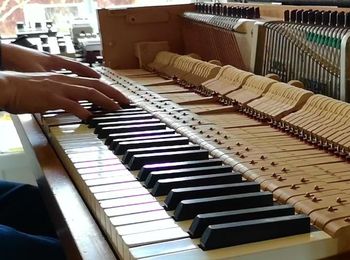 Piano with a mid-century design being played