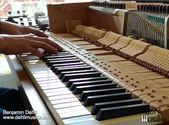 Piano with a mid-century design being played