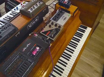 Piano with effects pedals and a 4-track tape recorder