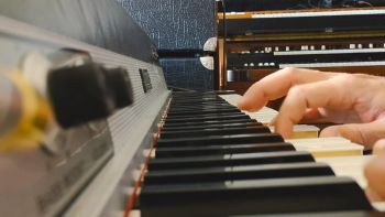 A Fender Rhodes electric piano being played