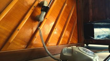 Louis Zwicki Pianette with an old telephone, tape recorder and coffee cup on top