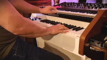 A Mellotron M4000D with a  Sequential Circuits Pro-One synthesizer on top being played
