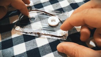 A cassette tape being modified