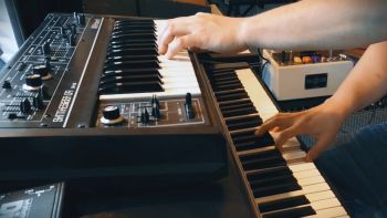 A Rhodes electric piano with a Roland SH-2 synthesizer on top being played