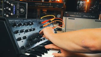 A Korg MS-20 synthesizer being played with a Gamechanger Audio PLASMA Pedal on top