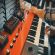 A Yamaha YC-25D combo organ with effects pedals on top being played