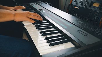 A Yamaha DX7 synthesizer being played