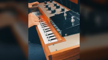 A Therevox synthesizer being played with an Ace Tone Fuzz Master pedal on top