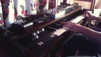 A Korg CX-3 organ with effects pedals on top