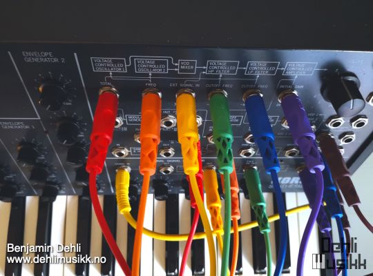 A Korg MS-20 synthesizer with rainbow colored patch cables