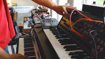 A Korg MS-20 synthesizer and a Fender Rhodes electric piano being played