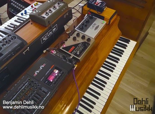 Piano with effects pedals and a 4-track tape recorder