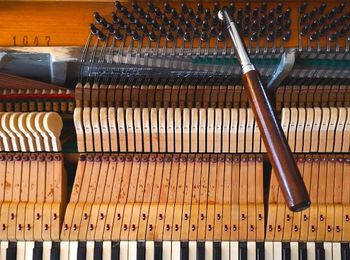 Piano with a tuning wrench