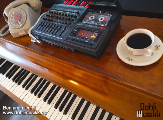 Louis Zwicki Pianette with an old telephone, tape recorder and coffee cup on top