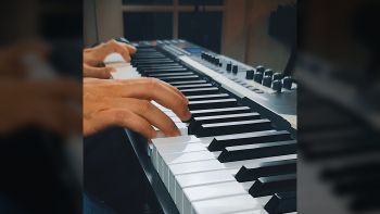 A MIDI controller keyboard being played